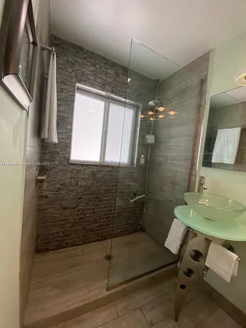 a bathroom with a mirror and a shower