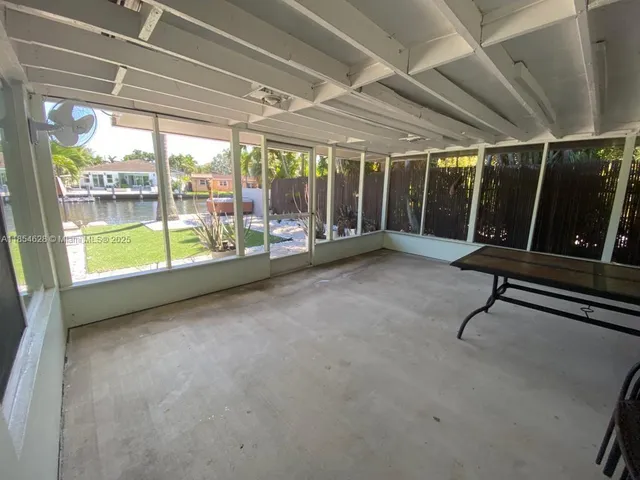 a view of a room with wooden floor and iron stairs