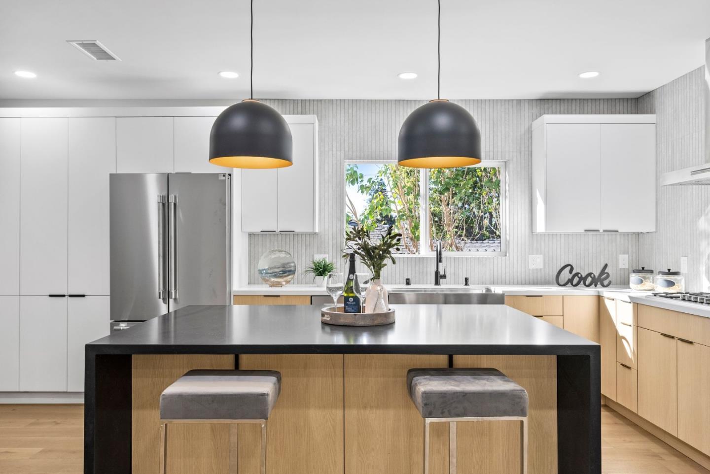 a kitchen with stainless steel appliances a sink a stove and a wooden floors