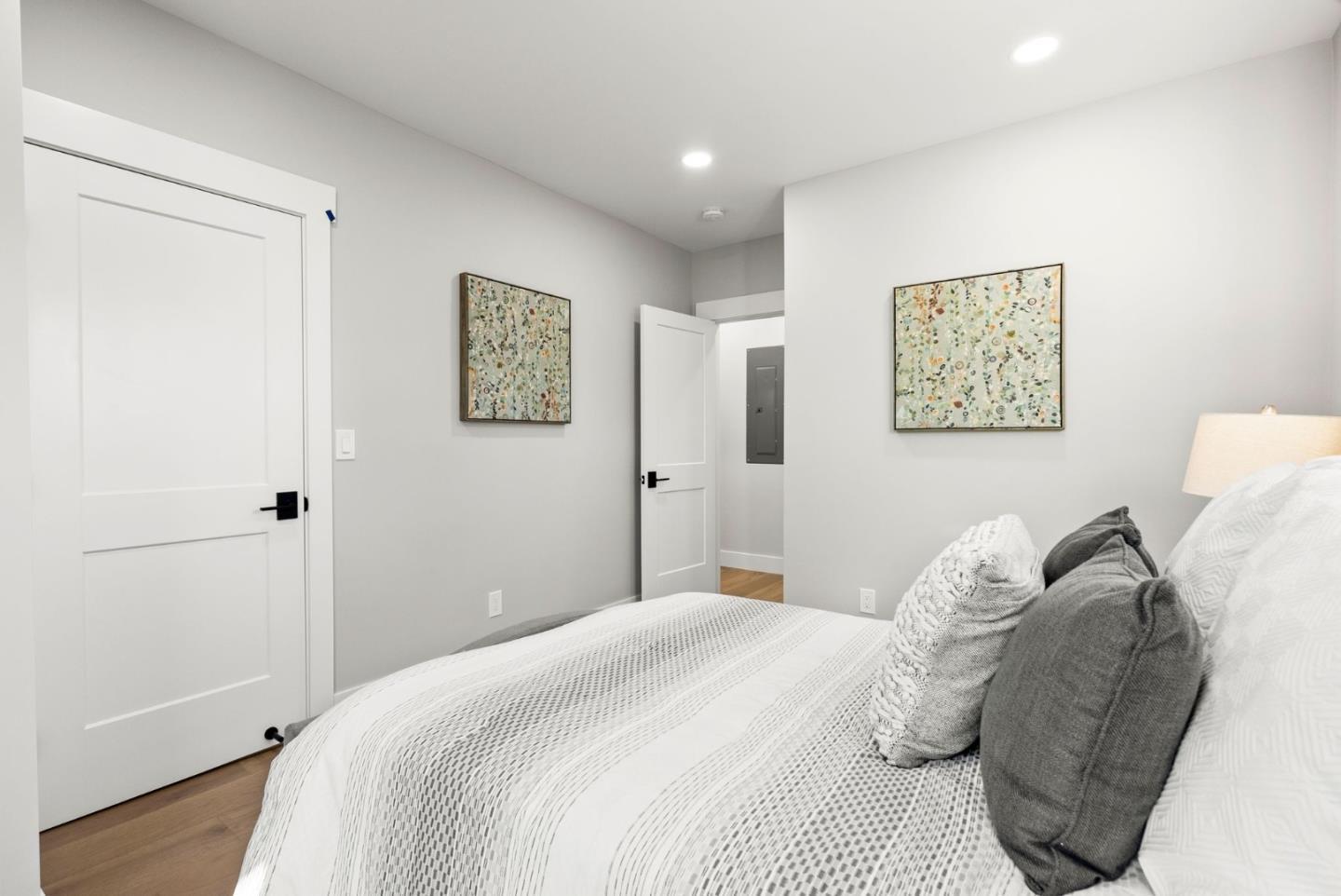 1587 Valota Road Redwood City, CA 94061 - Photo 15 of 42 a bedroom with a bed and a painting on the wall