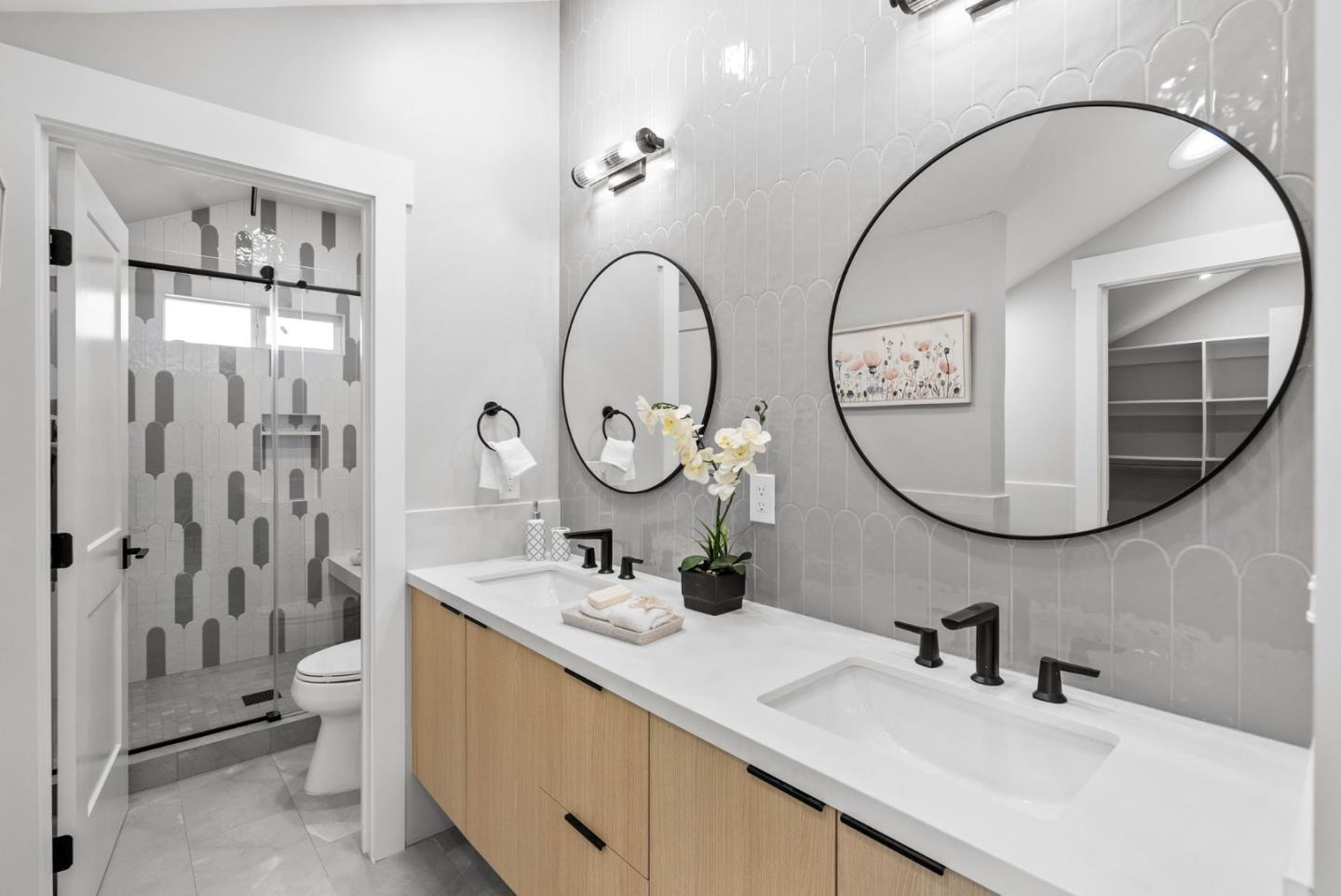 1587 Valota Road Redwood City, CA 94061 - Photo 21 of 42 a bathroom with a double vanity sink mirror and toilet