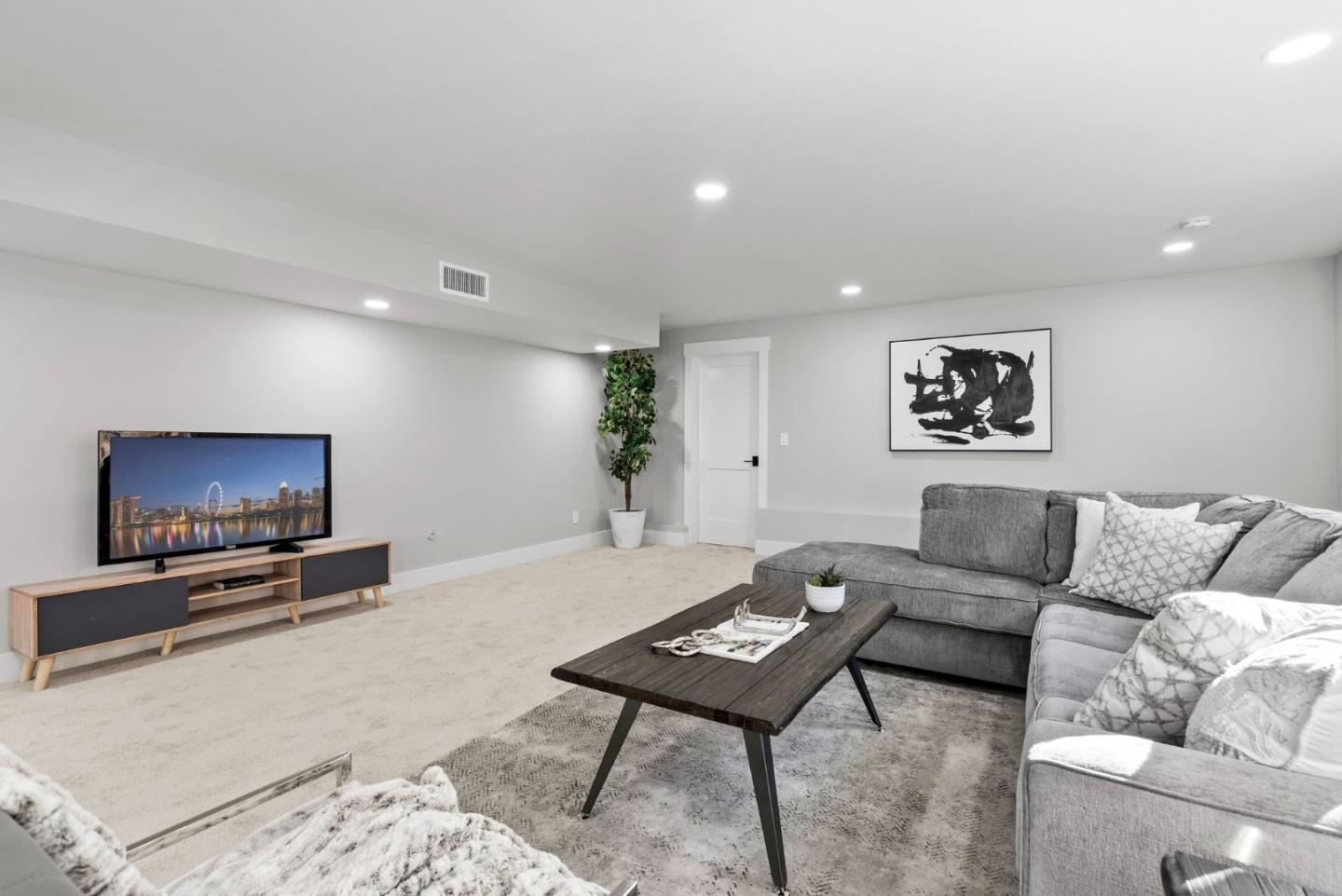 1587 Valota Road Redwood City, CA 94061 - Photo 28 of 42 a living room with furniture and a flat screen tv