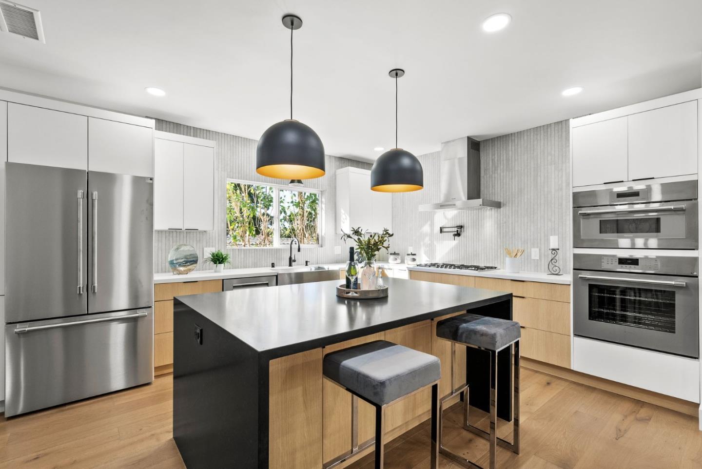 1587 Valota Road Redwood City, CA 94061 - Photo 3 of 42 a kitchen with stainless steel appliances granite countertop a sink a stove a refrigerator and island with wooden floor