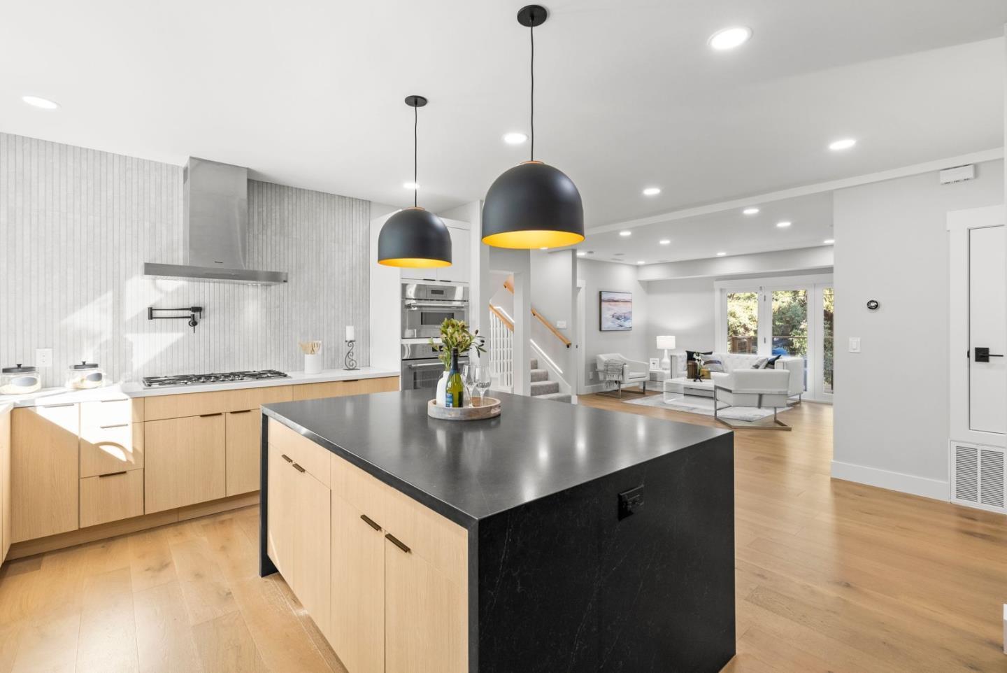 1587 Valota Road Redwood City, CA 94061 - Photo 5 of 42 a kitchen with stainless steel appliances granite countertop a sink a stove and a wooden floor