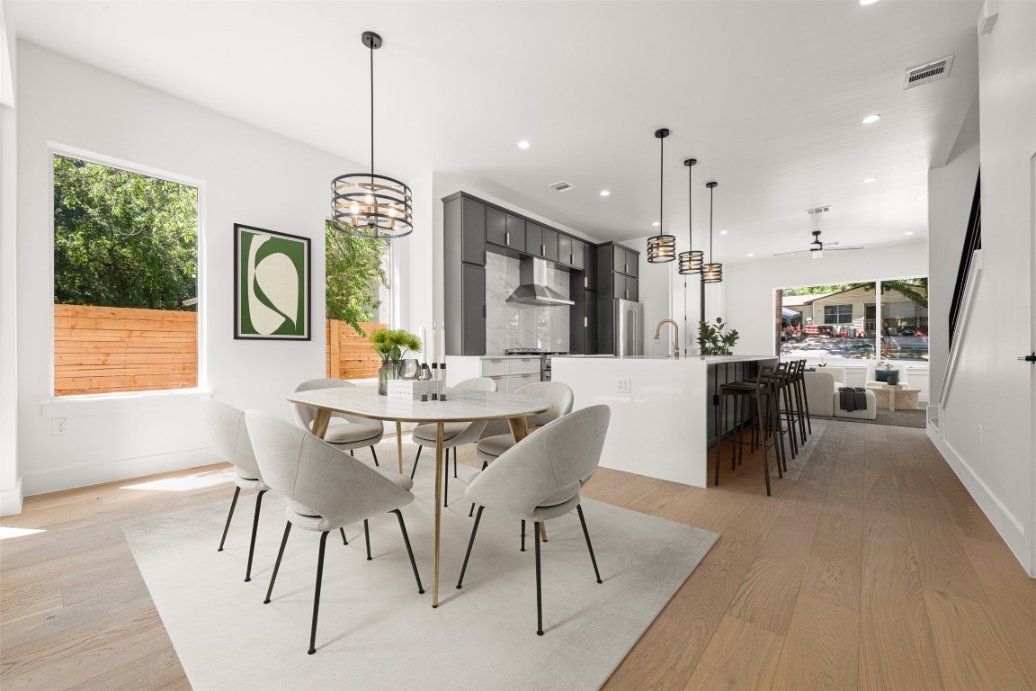 a view of a dining room with furniture window and wooden floor
