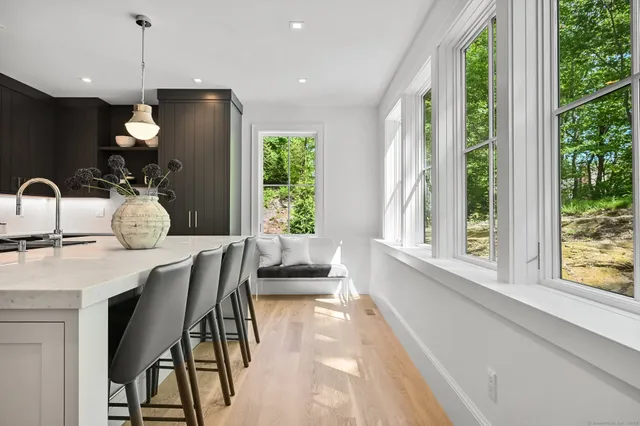 a view of a livingroom with wooden floor and furniture