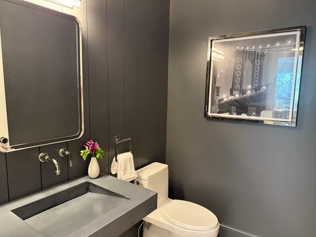a hallway with white cabinets and wooden floor
