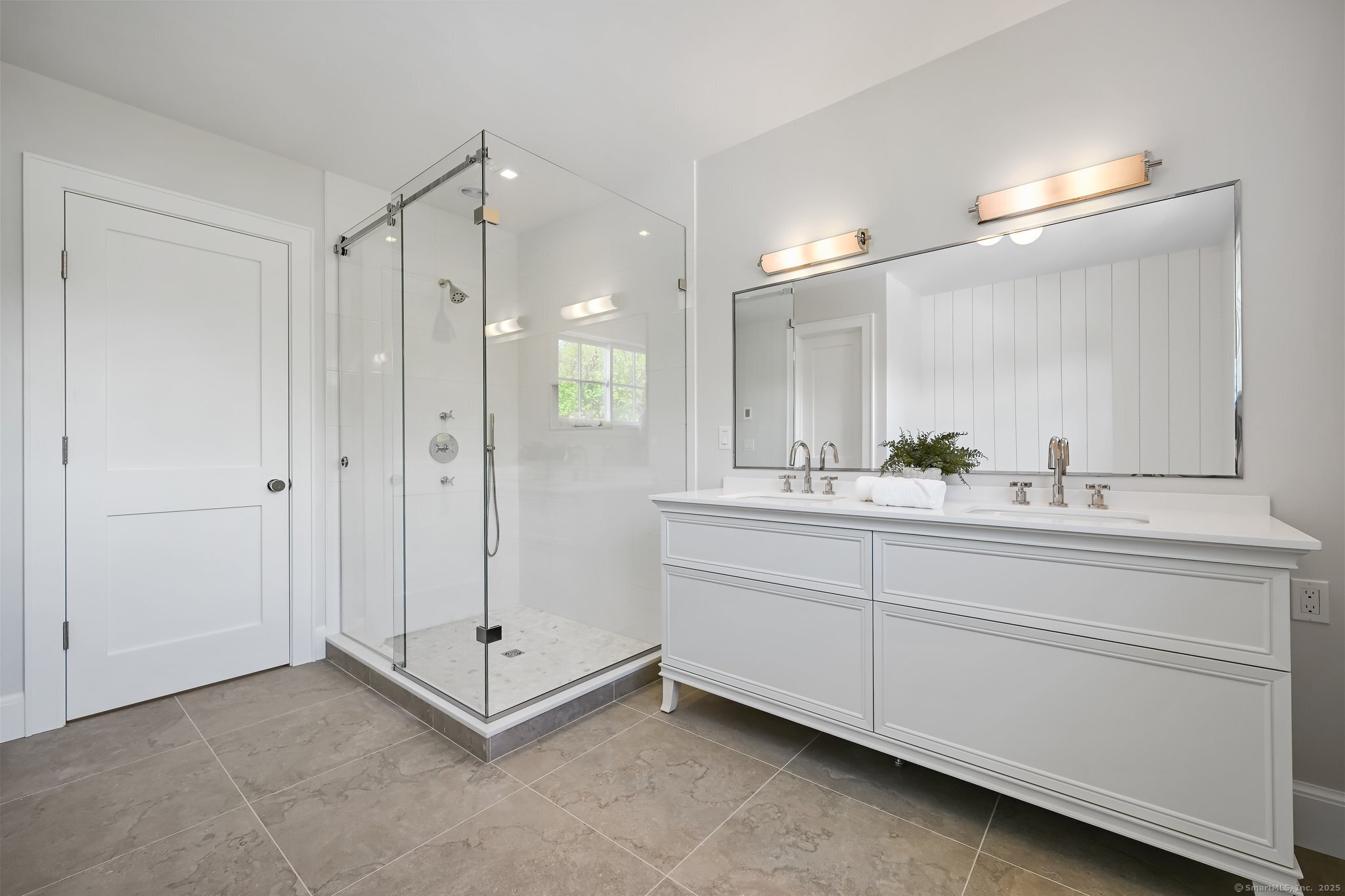 171 Compo Road South Westport, CT 06880 - Photo 20 of 39 a bathroom with a double vanity sink a mirror and a shower