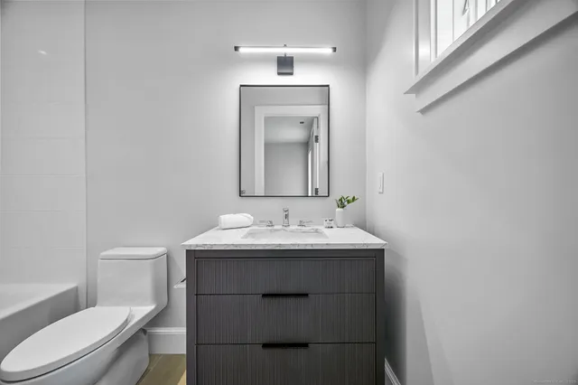 a view of empty room with wooden floor and window