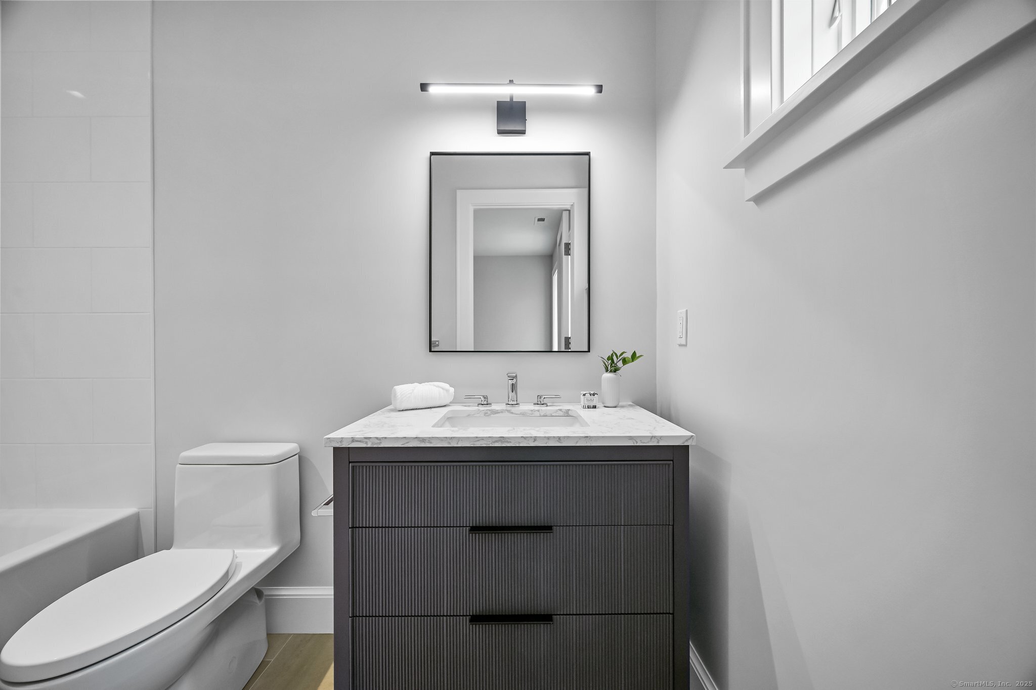 171 Compo Road South Westport, CT 06880 - Photo 23 of 39 a bathroom with a toilet sink and mirror