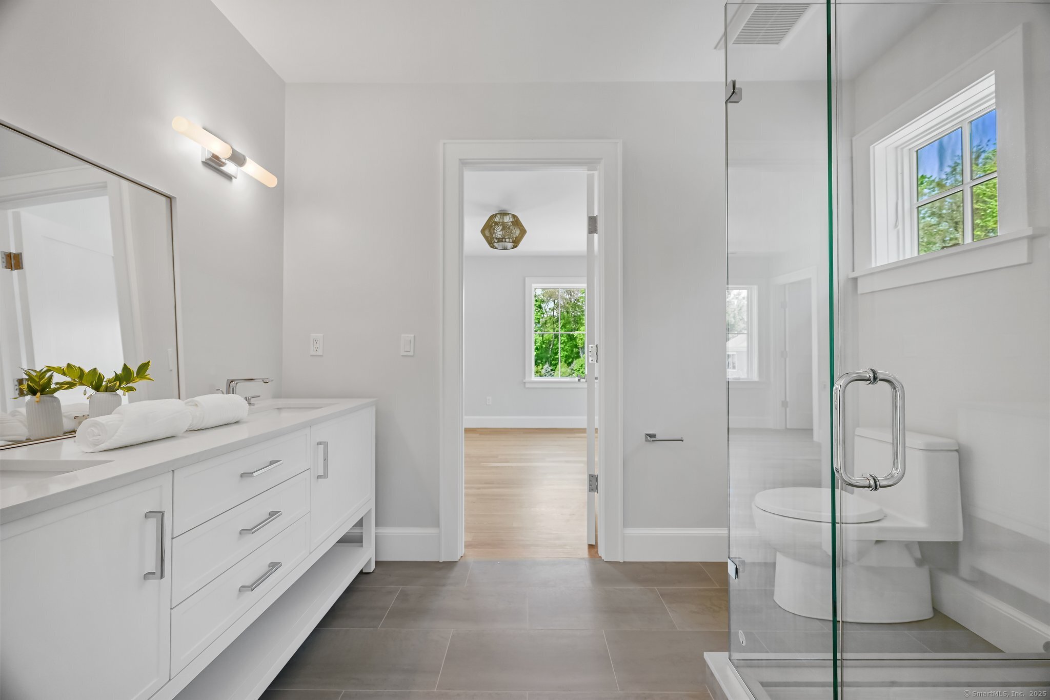 171 Compo Road South Westport, CT 06880 - Photo 26 of 39 a bathroom with a double vanity sink and a mirror