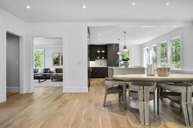 a kitchen with a sink and wooden floor