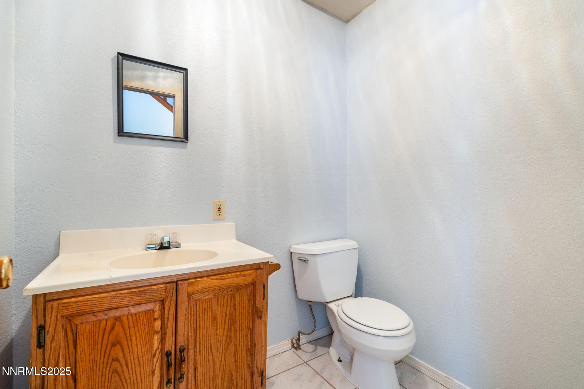 21615 Dortort Drive Reno, NV 89521 - Photo 14 of 52 a white toilet sitting next to a white sink