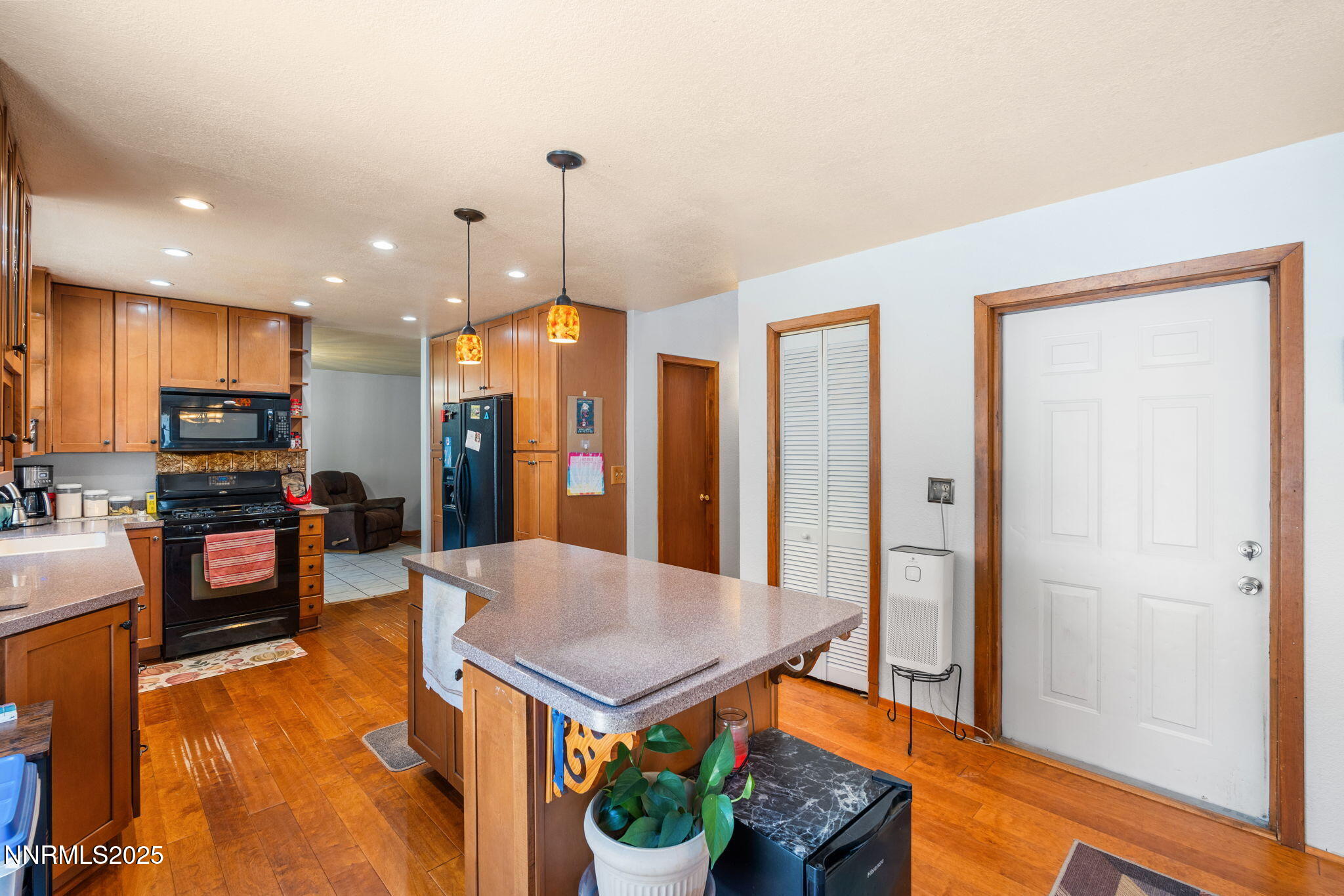 21615 Dortort Drive Reno, NV 89521 - Photo 20 of 52 a kitchen with stainless steel appliances granite countertop a refrigerator a stove and a sink with wooden floor