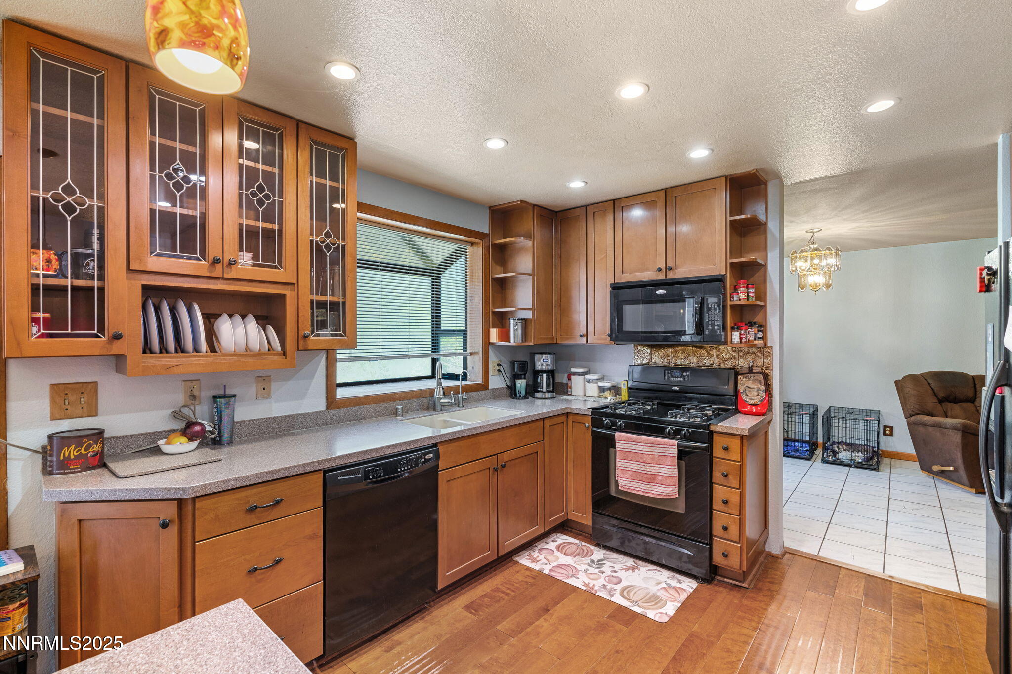 21615 Dortort Drive Reno, NV 89521 - Photo 22 of 52 a kitchen with stainless steel appliances granite countertop wooden cabinets a sink dishwasher a stove and a refrigerator with wooden floor