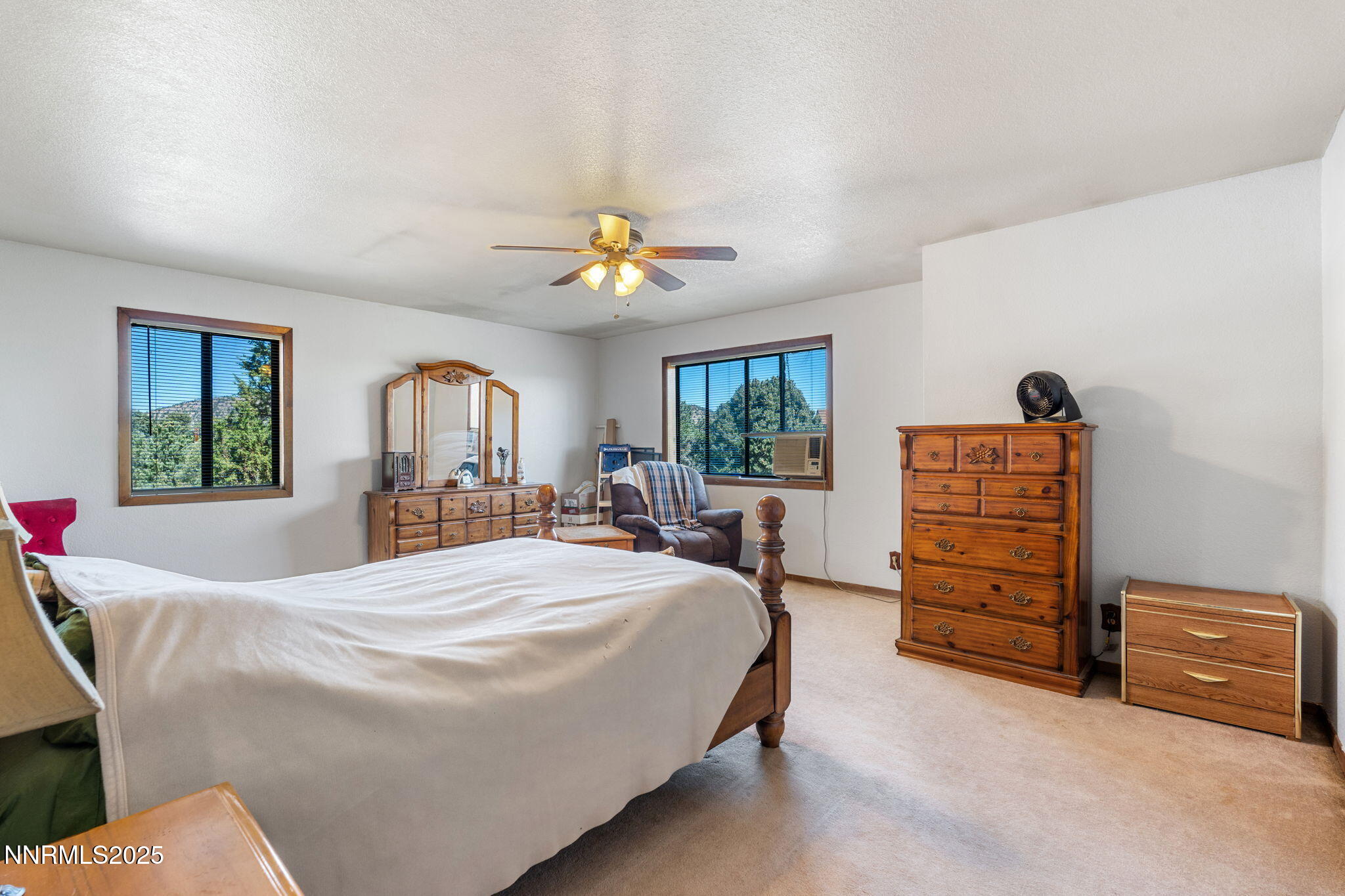 21615 Dortort Drive Reno, NV 89521 - Photo 30 of 52 a bedroom with a bed a dresser and a window