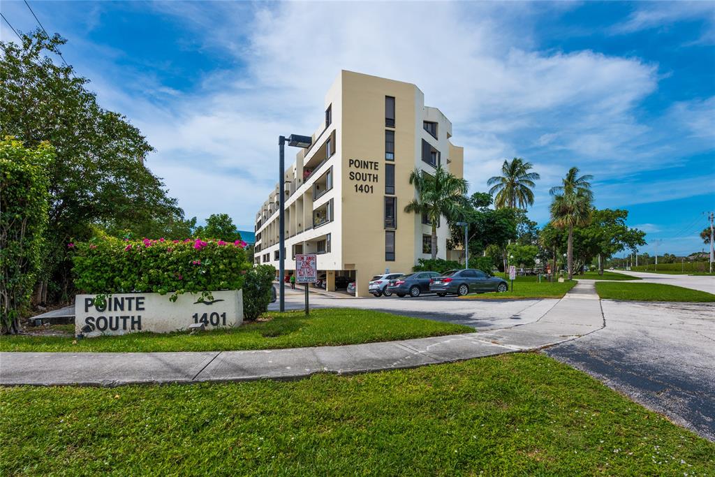 1401 South Federal Highway, Unit 122 Boca Raton, FL 33432 - Photo 1 of 29 a front view of a house with a yard and fountain