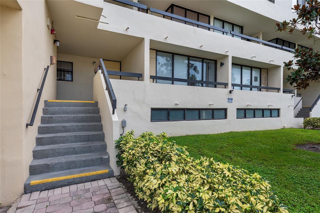 1401 South Federal Highway, Unit 122 Boca Raton, FL 33432 - Photo 2 of 29 a front view of a house with a yard