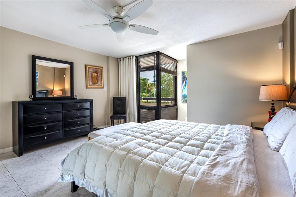 1401 South Federal Highway, Unit 122 Boca Raton, FL 33432 - Photo 24 of 29 a bedroom with a bed and a dresser