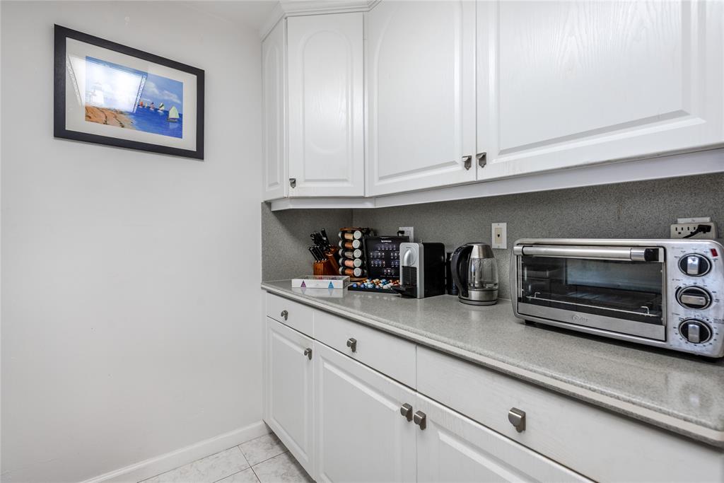 1401 South Federal Highway, Unit 122 Boca Raton, FL 33432 - Photo 6 of 29 a kitchen with white cabinets and black appliances