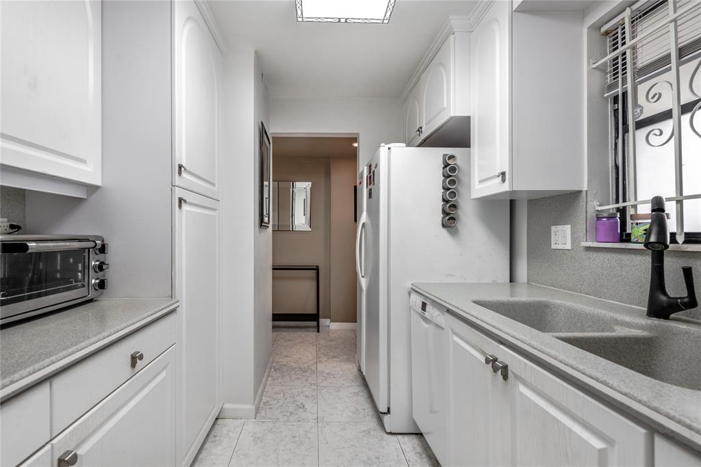 1401 South Federal Highway, Unit 122 Boca Raton, FL 33432 - Photo 9 of 29 a kitchen with stainless steel appliances granite countertop a sink and a refrigerator