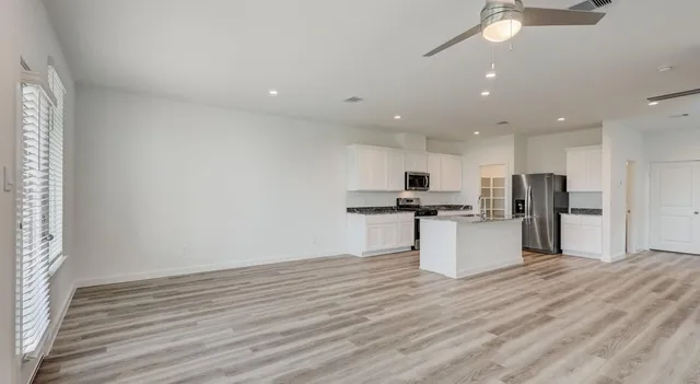 a view of kitchen with refrigerator sink and stove