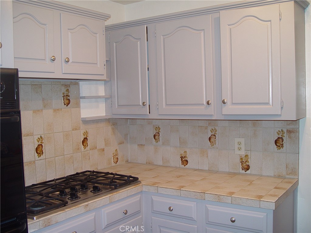 125 7th Street Manhattan Beach, CA 90266 - Photo 19 of 20 a kitchen with granite countertop white cabinets and stainless steel appliances