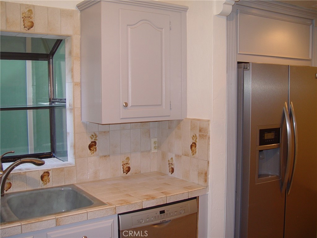 125 7th Street Manhattan Beach, CA 90266 - Photo 20 of 20 a kitchen with stainless steel appliances granite countertop a refrigerator and a sink