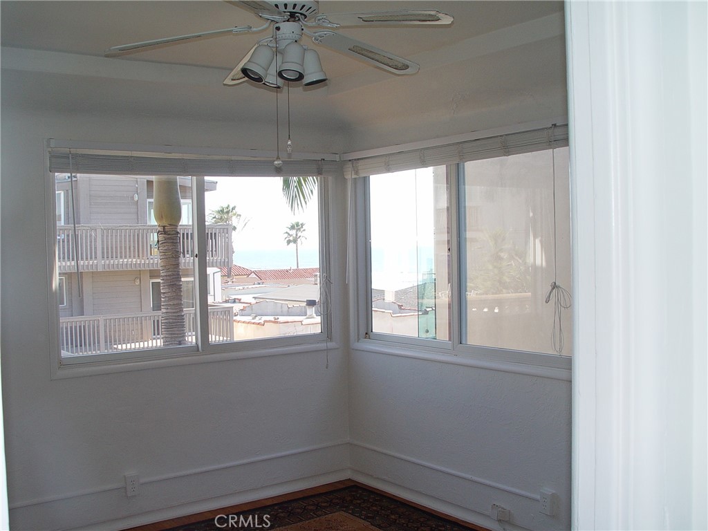 125 7th Street Manhattan Beach, CA 90266 - Photo 10 of 20 a view of empty room with windows and chandelier