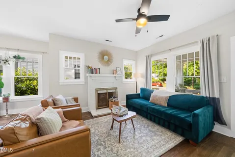 a living room with furniture and a fireplace