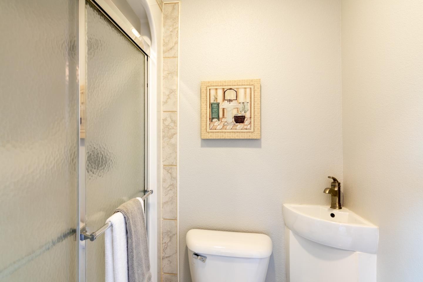 464 Greathouse Drive Milpitas, CA 95035 - Photo 22 of 27 a white toilet sitting next to a bathroom sink