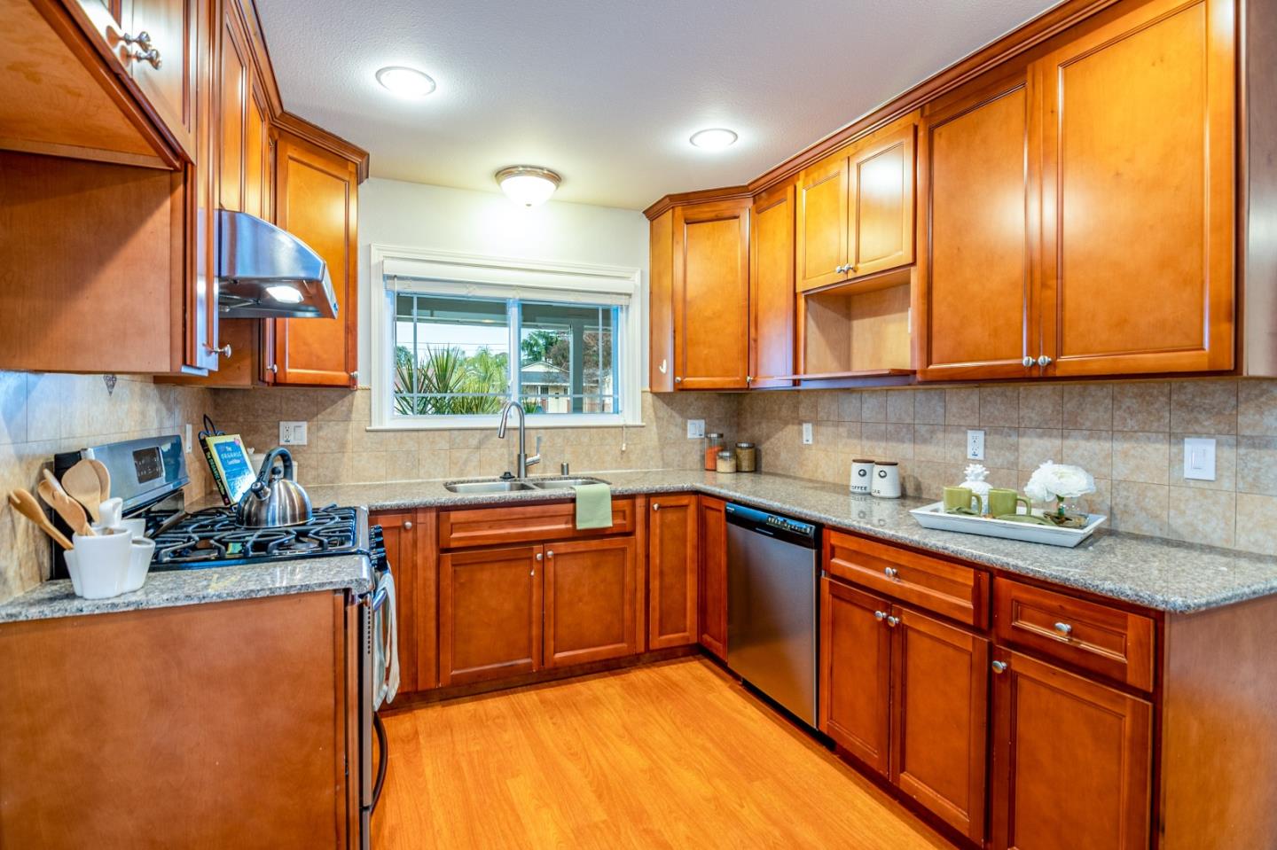 464 Greathouse Drive Milpitas, CA 95035 - Photo 7 of 27 a kitchen with stainless steel appliances granite countertop wooden cabinets a sink a stove a washer and dryer