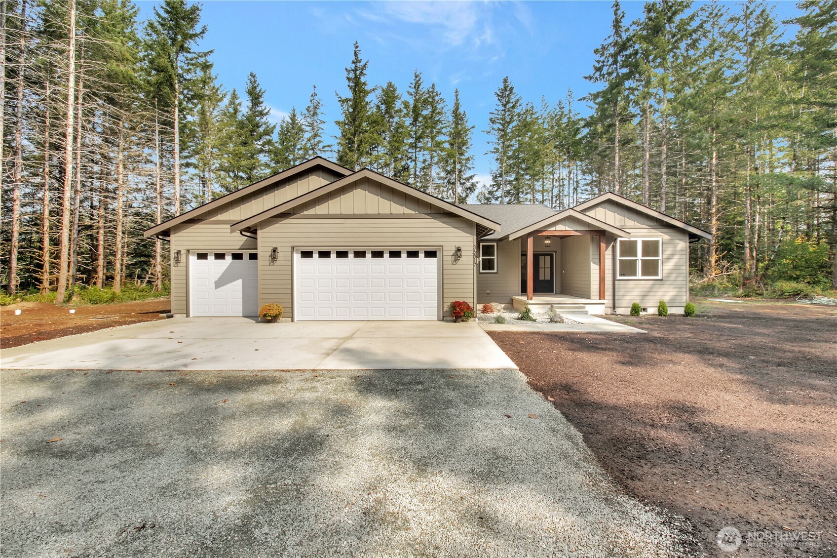 36817 State Rte 530 Northeast Arlington, WA 98223 - Photo 1 of 40 a front view of a house with a yard and garage