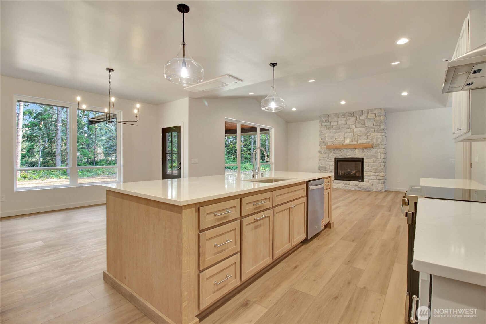 36817 State Rte 530 Northeast Arlington, WA 98223 - Photo 13 of 40 a kitchen with kitchen island granite countertop a stove oven and a wooden floors