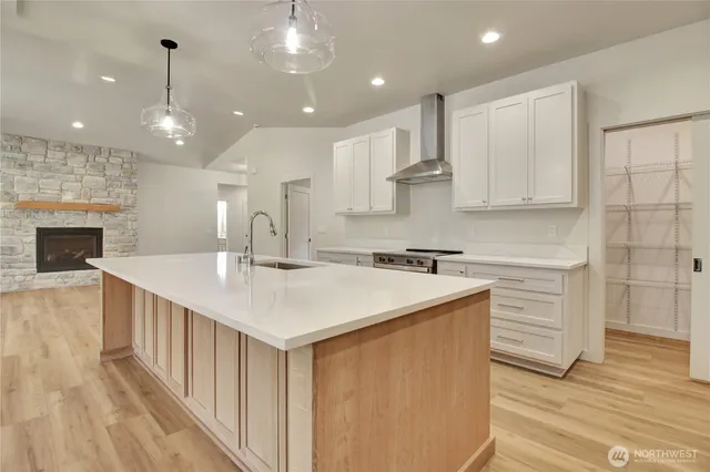 a kitchen with kitchen island a sink stainless steel appliances and cabinets