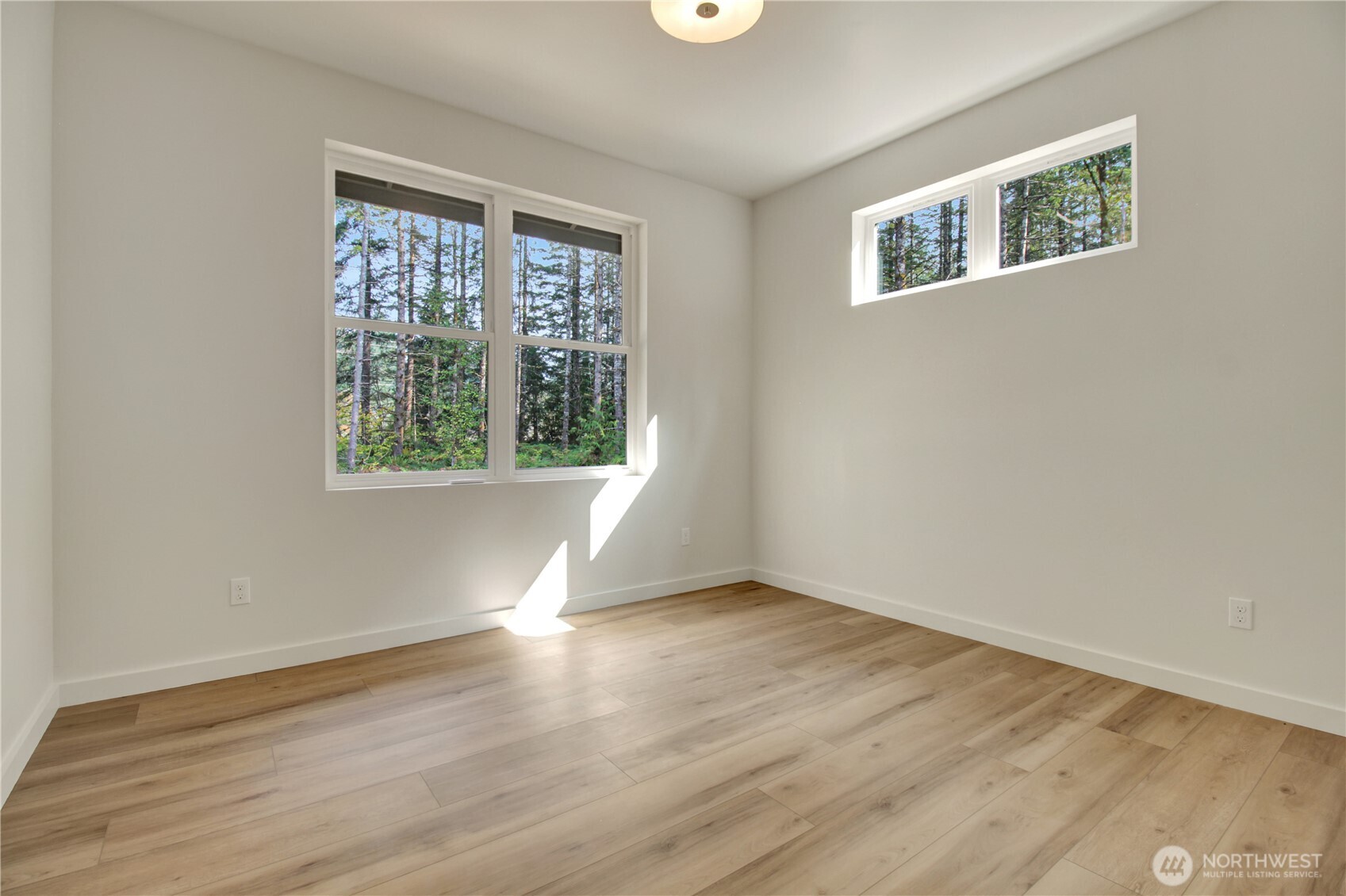 36817 State Rte 530 Northeast Arlington, WA 98223 - Photo 27 of 40 an empty room with wooden floor and windows