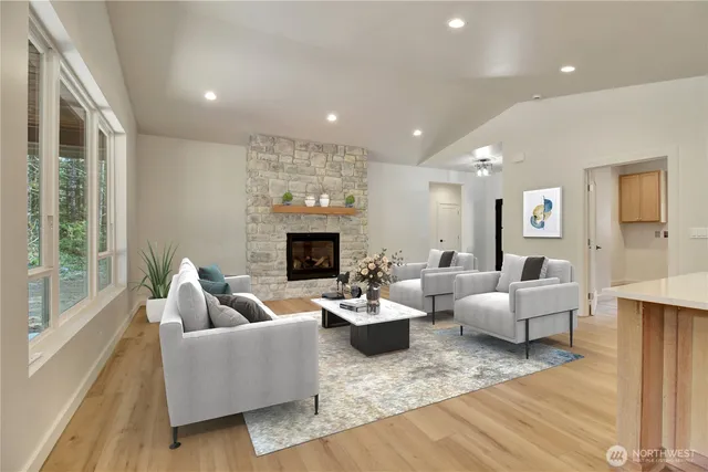 a living room with fireplace furniture and a large window