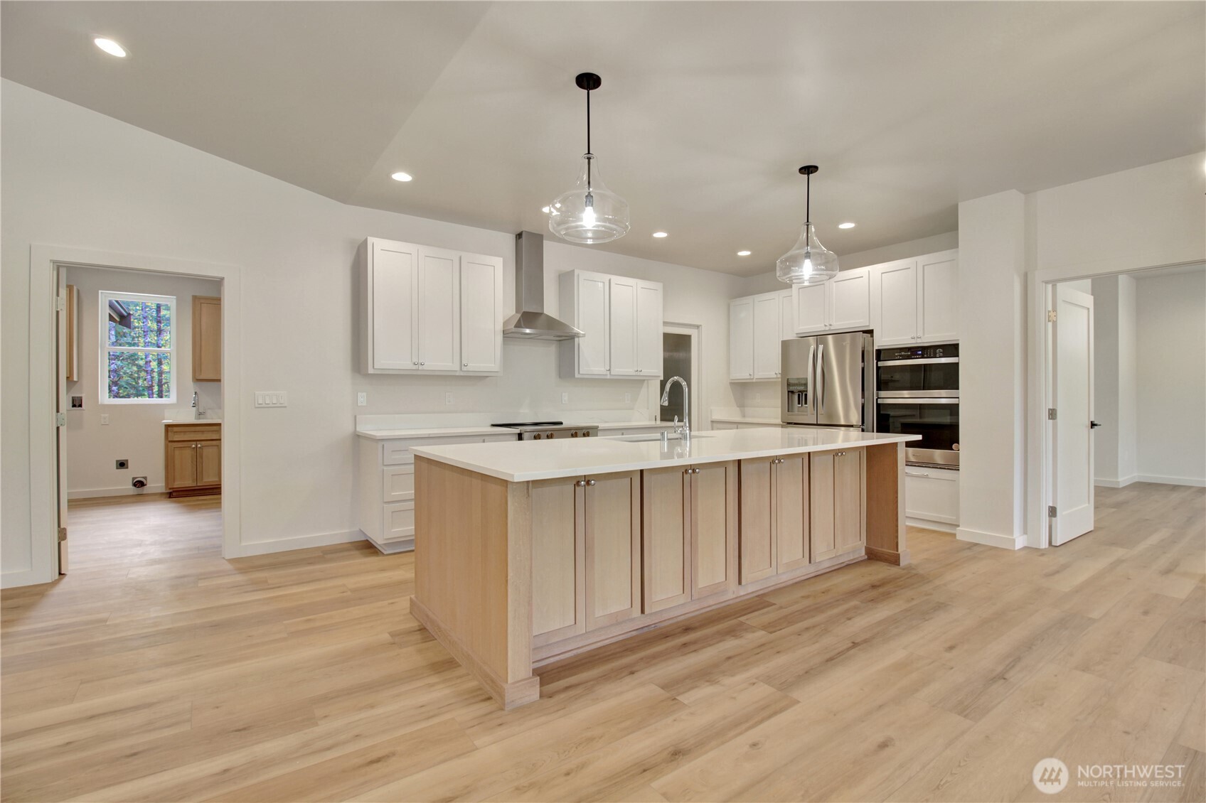 36817 State Rte 530 Northeast Arlington, WA 98223 - Photo 7 of 40 a large kitchen with stainless steel appliances kitchen island a large counter top and wooden floors