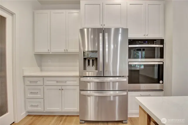 a kitchen with appliances and cabinets