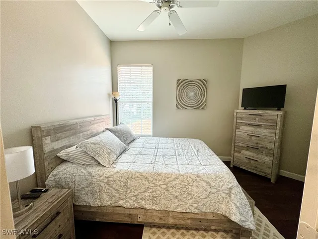 a bedroom with a bed and a television