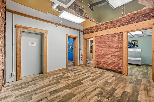 a view of an empty room with a brick wall