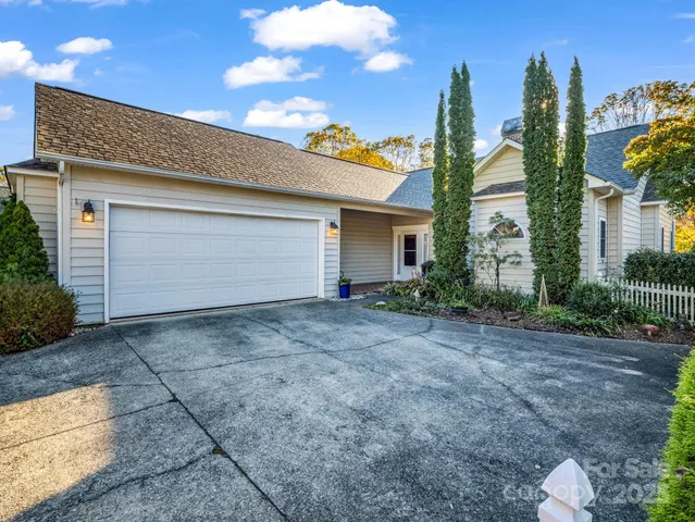 a view of a house with a yard and palm trees