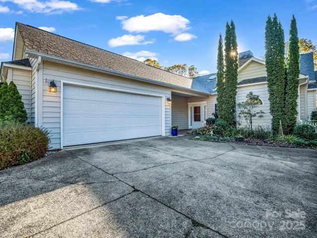 a view of a house with a yard and garage