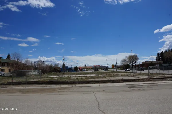 a view of a cars park on the side of a road