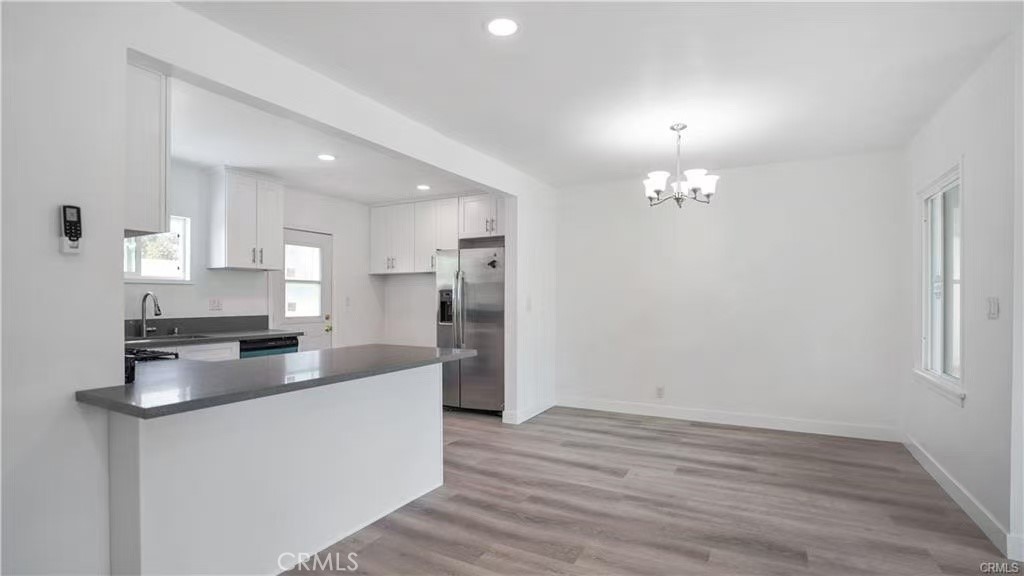 4249 Filhurst Avenue Baldwin Park, CA 91706 - Photo 6 of 24 a kitchen with kitchen island a sink stainless steel appliances and cabinets
