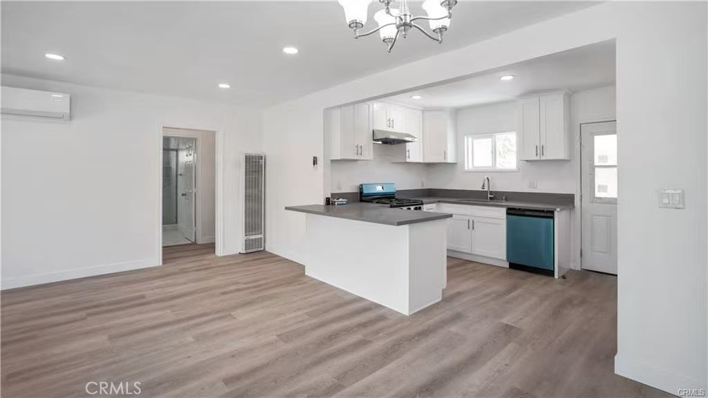 4249 Filhurst Avenue Baldwin Park, CA 91706 - Photo 7 of 24 a kitchen with granite countertop a stove top oven a sink dishwasher and a refrigerator with wooden floor