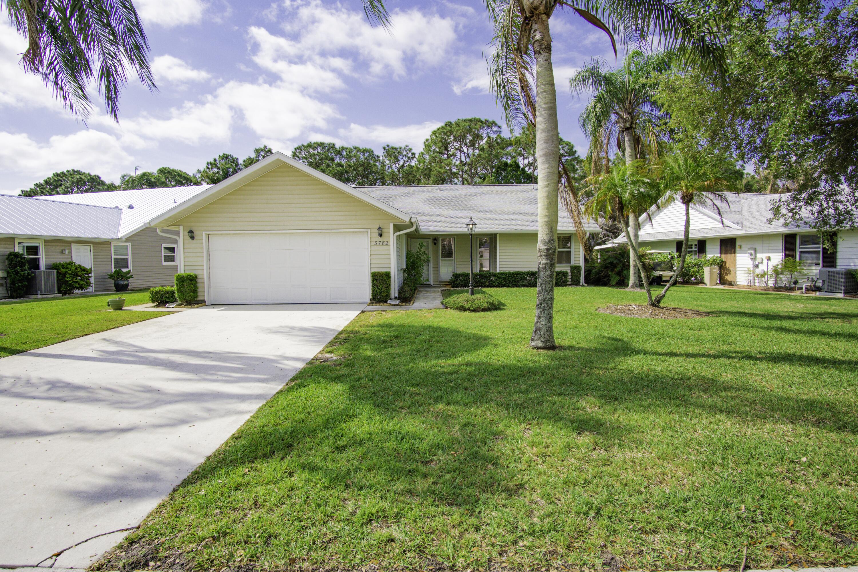 3782 Southeast Canvas Back Place Stuart, FL 34997 - Photo 1 of 19 a view of a house with a yard