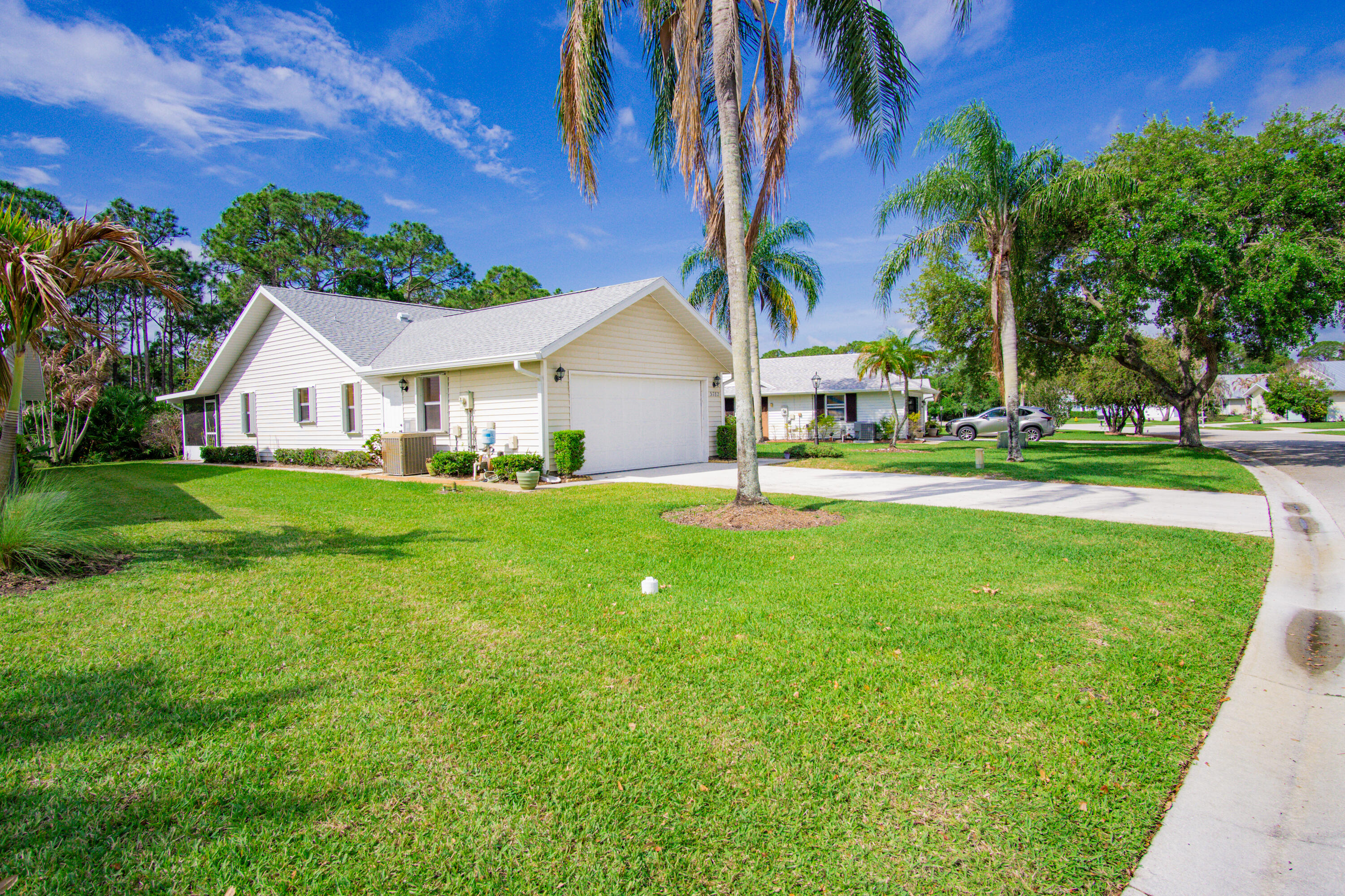 3782 Southeast Canvas Back Place Stuart, FL 34997 - Photo 18 of 19 a front view of a house with a yard and garage