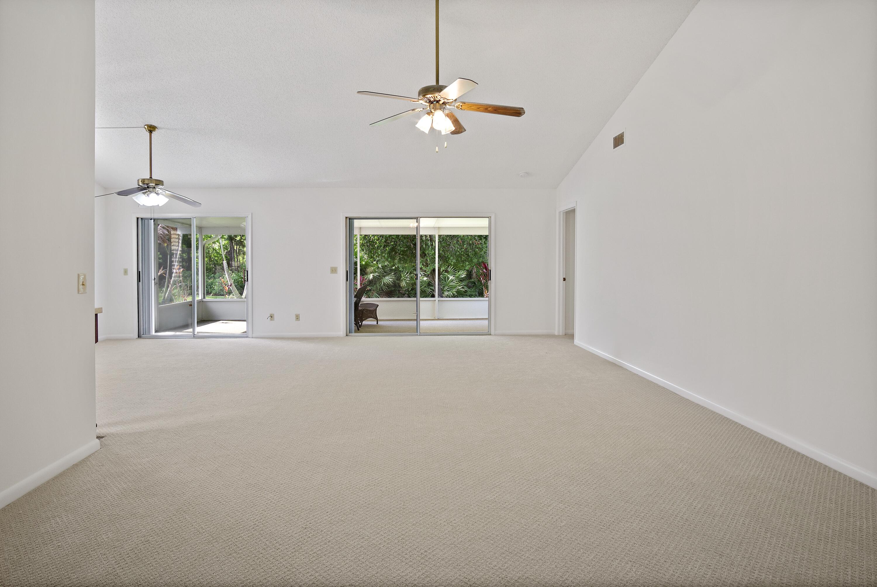 3782 Southeast Canvas Back Place Stuart, FL 34997 - Photo 3 of 19 a view of a livingroom with a ceiling fan and window