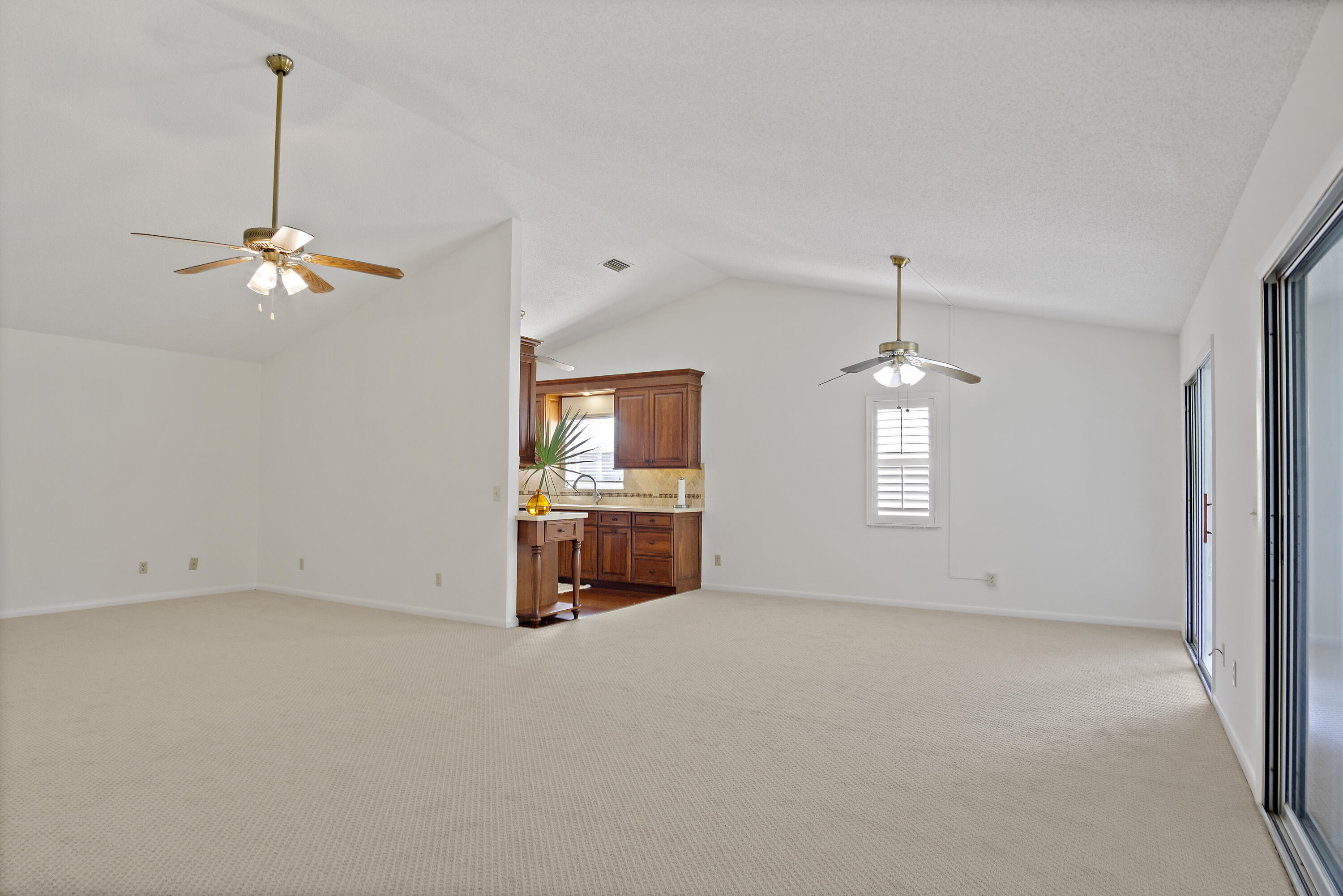 3782 Southeast Canvas Back Place Stuart, FL 34997 - Photo 4 of 19 an empty room with windows and fan